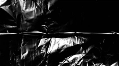 Plastik ambalaj dokusu siyah arkaplan üzerinde kaplama etkisi. Gizlenmek için plastik kolları küçült. Beyaz plastik