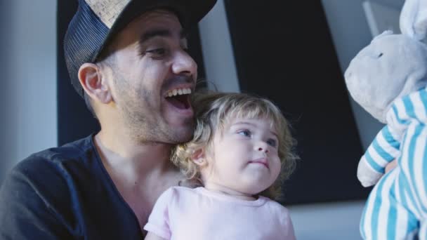 Happy father playing with little daughter and stuffed animal — Stock Video