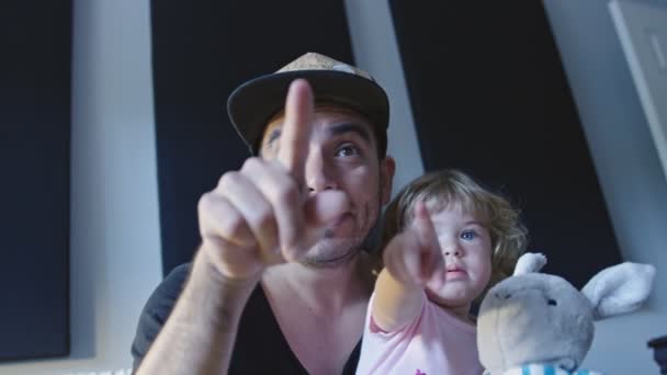 Father and daughter pointing towards camera during video chat — Stock Video