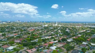 Aerial drone view of a residential neighborhood in Fort Lauderdale, Florida. This footage highlights the relaxed suburban lifestyle and coastal charm of South Florida, perfect for real estate, travel, or city landscape projects.