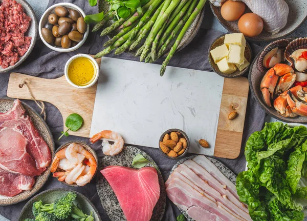 Food background with meat, eggs, fish, seafood, and vegetables. Top view, copy space