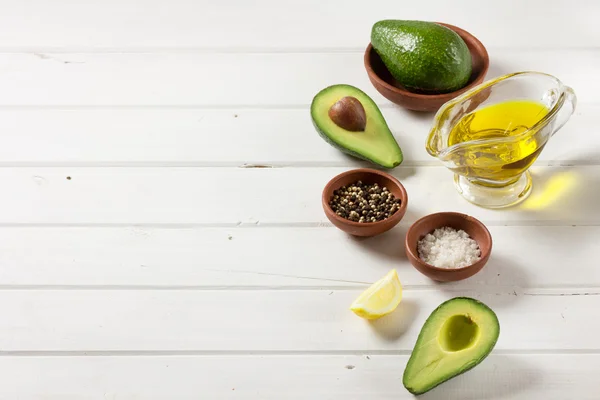 Abacate, e outros ingredientes para guacamole molho na mesa . — Fotografia de Stock