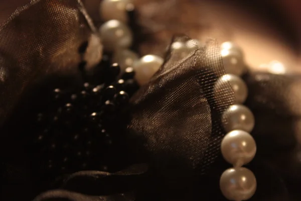 Pearls and black decoration — Stock Photo, Image