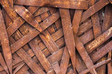 blades of rusty swords, a background of a large number of vintage, deformed blades of swords, erosion of blades that once served as weapons, close-up 