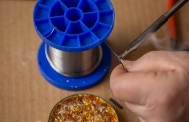 Close up of a soldering iron melts rosin clipart