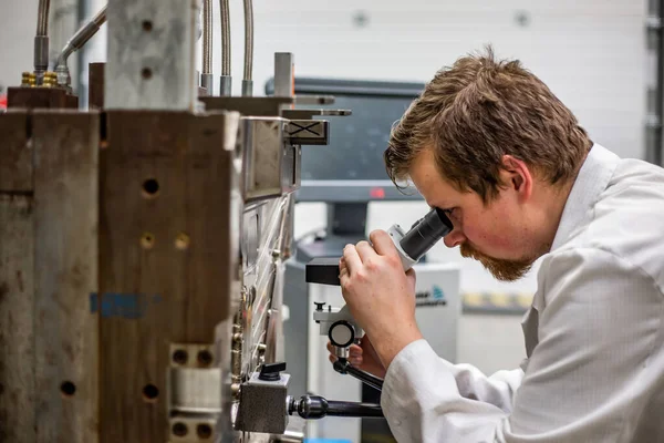 Man checking or doing maintenance the plastic injection mold for plastic production, industrial concept