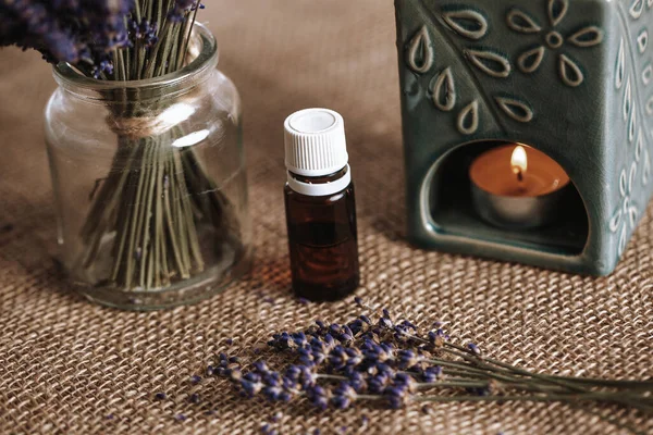 Aroma lamp with an aromatic oil and burning candle with bucket of lavender in the glass, aromatherapy concept — Fotografia de Stock