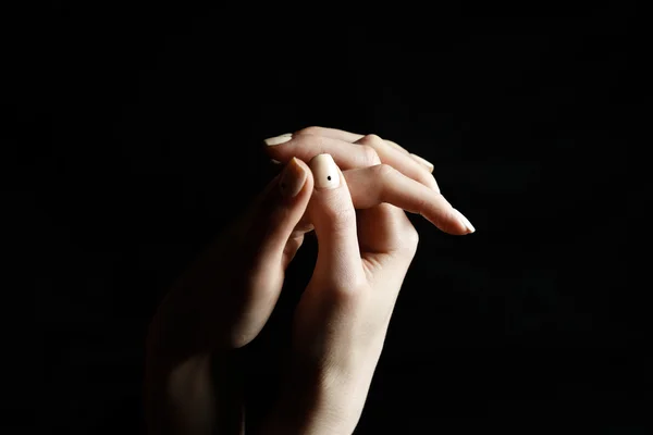 Female hands on black background shows gestures — Stock Photo, Image