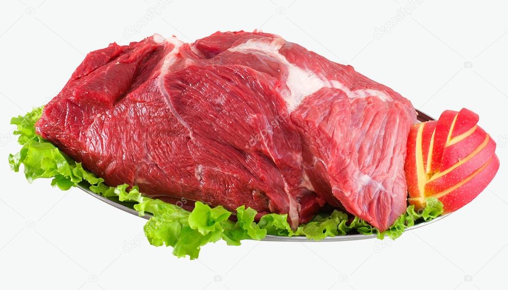 Pieces of fresh meat beef slab decorated with greens and vegetables isolated on white background