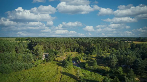 Low flyover over a small wild river on a summer day, river Grabia, Poland.