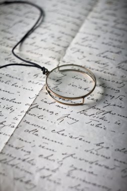 Old monocle on old original handwritten Polish letter clipart
