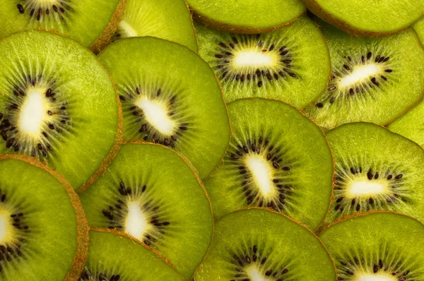 Kiwi fruit slices as background — Stock Photo, Image