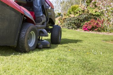 Mowing the lawn with tractor clipart