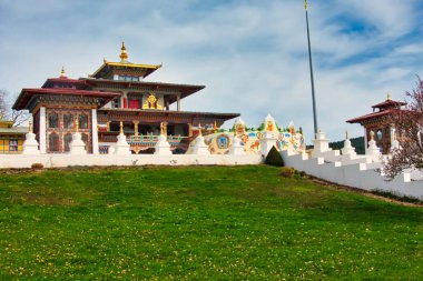 LA BOULAYE, FRANCE - Nisan 2018. Ünlü Bin Budha Tapınağı 'nın açık hava manzarası. Farklı boyutlarda Buda heykelleri, birçok Thangka tabloları, duvar freskleri ve frizleri olan üç katlı bir Bhutan tarzıdır.