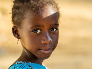 Bour, Senegal - 2021 Temyiz Dairesi. Tanımlanamayan genç Senegalli çocukların portresi, kameraya bakıyor. Güzel cilt, saçlar, açık renk. Açık havada.