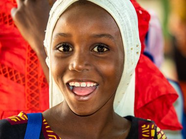 Bour, Senegal - 2021 Temyiz Dairesi. Tanımlanamayan genç Senegalli çocuğun portresi, kameraya bakıyor. Güzel cilt, saçlar, açık renk. Mutlu bir duygu. Açık havada.
