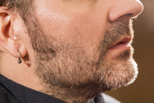 Hairdresser, cutting beard in her work place