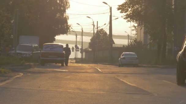 Una chica, autoestop, peatonal y el tráfico por carretera en la iluminación de la ciudad — Vídeos de Stock