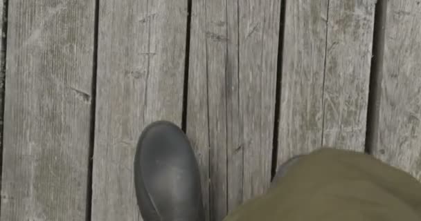 Walking legs in boots on the road, top view — Stock Video