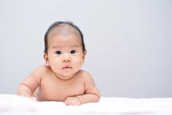 Asian baby lying on stomach — Stock Photo, Image