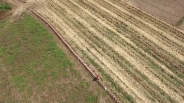 Bir adam plastik drenaj borusu pirinç alan için hazırlanıyor
