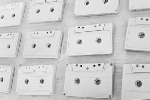 Audio cassettes are covered with white acrylic paint. Excellent retro. Creative decor.