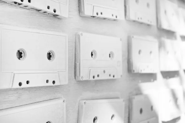 Audio cassettes are covered with white acrylic paint. Excellent retro. Creative decor. — Stock Photo, Image