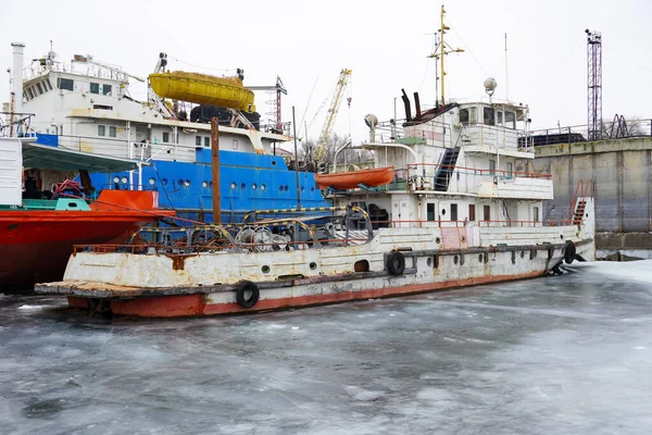 Old rusty motor ship. Volgograd. Krasnoarmeysky Zaton, wintering of ships on a frozen river