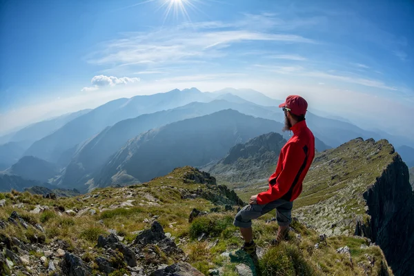 Senderista mirando por encima de las cordilleras — Foto de Stock