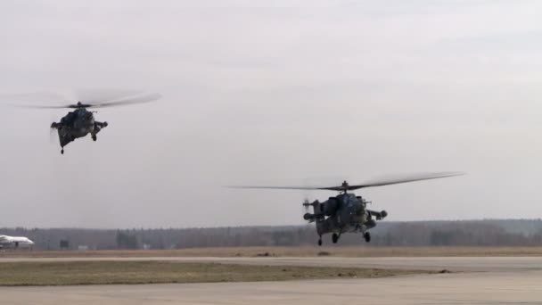 Military helicopters fly over airstrip — Stock Video