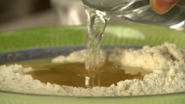 Cooking dough. View of chef add water to flour — Stock Video