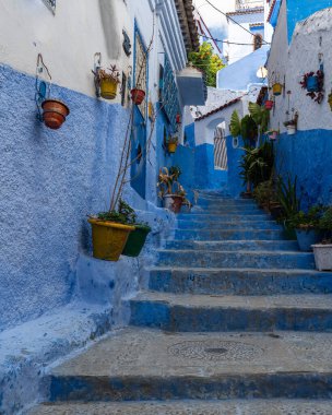 Colorful alley in Chefchaouen medina, know as the blue city for its typical houses and buildings, Morocco