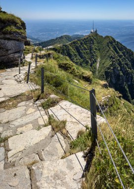 Hiking trail climbing up to Monte Generoso on the Swtizerland-Italy border, offering a scenic panorama of Lake Lugano and other northern Italy lakes