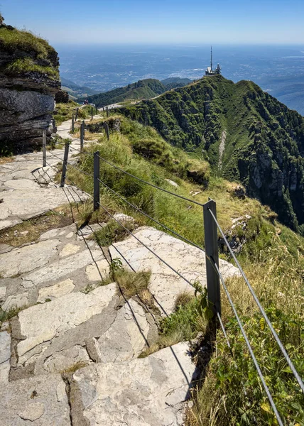 Hiking trail climbing up to Monte Generoso on the Swtizerland-Italy border, offering a scenic panorama of Lake Lugano and other northern Italy lakes