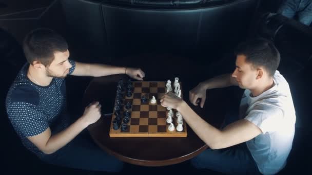 Two young men playing chess — Stock Video