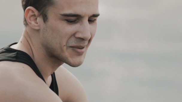 Close up portrait of a pensive young man smiling — Stock Video