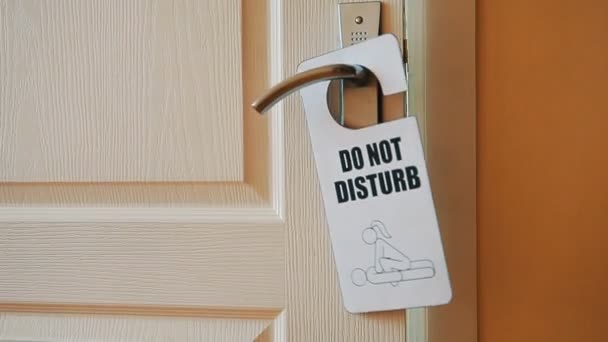 Door hanger do not disturb on handle of a hotel room — Stock Video