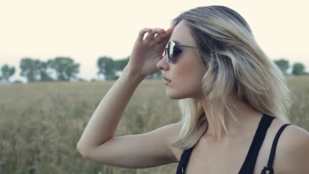 Portrait of beautiful blonde girl dressing sunglasses and posing — Stock Video