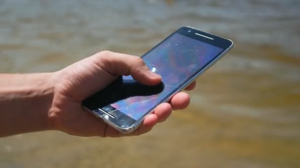 Использование смартфона на морском фоне — стоковое видео