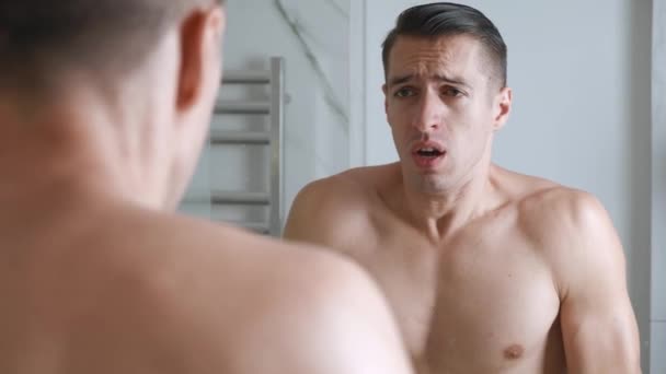 Un homme seul désespéré se regarde dans le miroir de la salle de bain et crie de chagrin. Jeune homme désespéré souffrant de dépression nerveuse, de problèmes de vie difficiles — Video