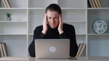 Stresli genç adam kas geriliminden muzdarip, aşırı çalışma ya da sabit çalışma tarzından dolayı acı çeken baş hisleri yaşıyor. Ofisteki görevler yüzünden bunalımda olan çalışanlar.