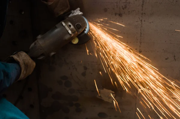 Working cutting rod with saw creating sparks — Stock Photo, Image