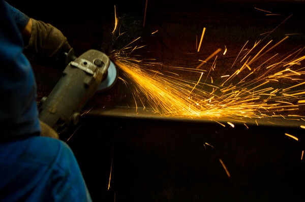 Working cutting rod with saw creating sparks