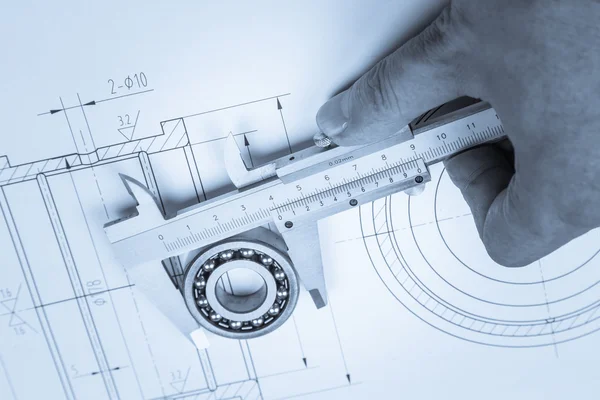 Tools and mechanisms detail on the background of technical drawings — Stock Photo, Image
