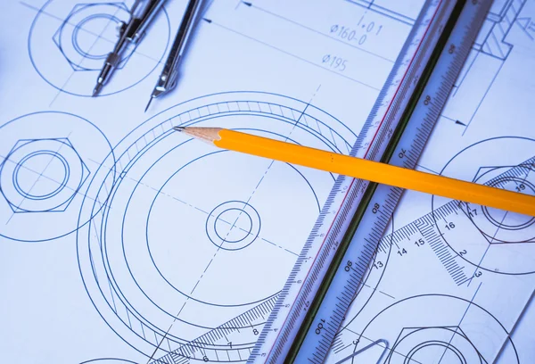 Architectural blueprints and blueprint rolls and a drawing instruments on the worktable — Stock Photo, Image