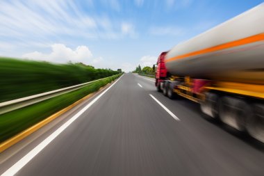 Motion blurred tanker truck on the highway. Chemical industry and pollution concept. clipart
