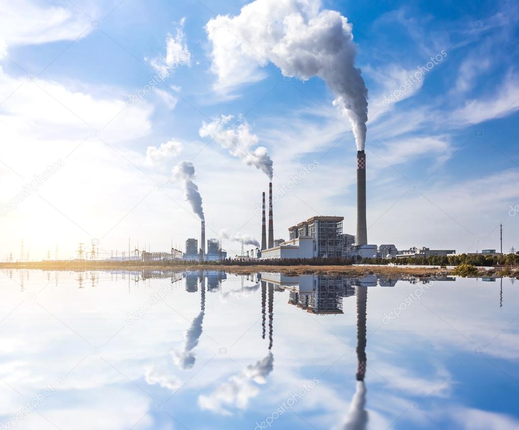 Smoking pipes of thermal power plant against blue sky