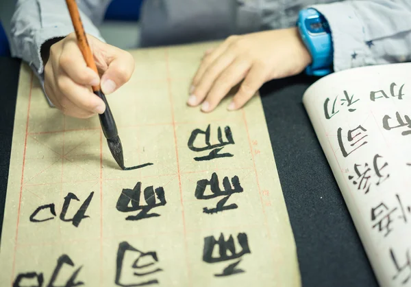 Crianças chinesas aprendem a escrever caracteres chineses, caligrafia é a cultura tradicional da China — Fotografia de Stock