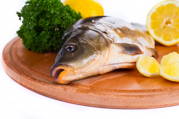 Fresh raw fish and food ingredients on table — Stock Photo, Image