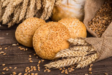 Ahşap masa arkasında pişmiş ekmek çeşitleri